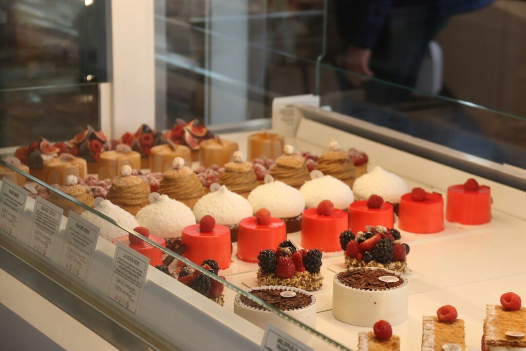 Assortment of colorful and decorative pastries in a display case.